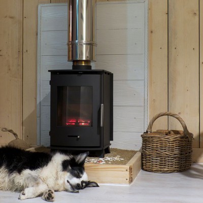 Dog warming up by the wood burner at Lusty Glaze dog friendly chalets