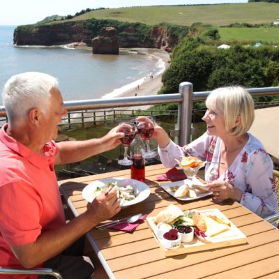 Couple eating overlooking Ladram Bay