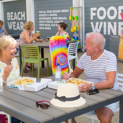 Couple eating fish and chips at Ladram Bay Holiday Park